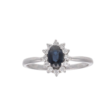 Anillo orla con piedra central de color y diamantes en oro de 18 K